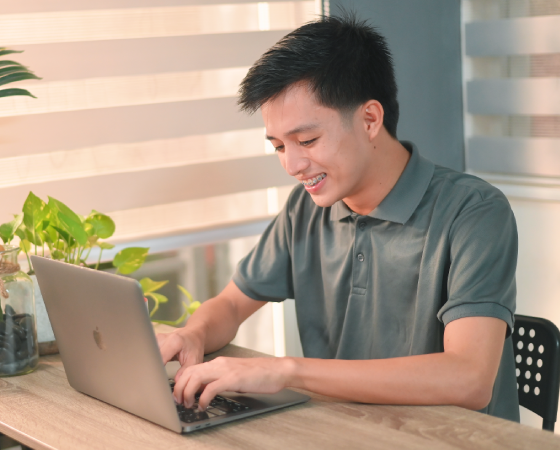 Happy Virtual Bears team member using his laptop